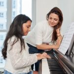 65949ec3a67a31bfec3f52a3_happy-proud-smiling-young-indian-woman-looking-her-teenage-daughter-playing-piano-home_274689-21293